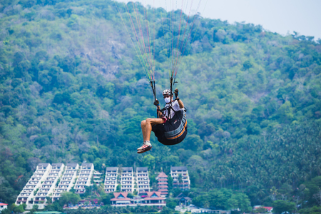 PHUKET, THAILAND -April 12 2014: An unidentified Paramania Paramotor show in Children day. Photo at Phuket, Thailandのeditorial素材