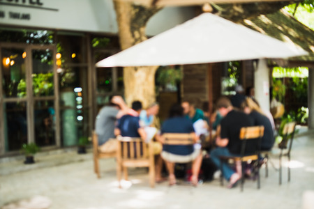 abstract blur of people sitting in the cafe bar outdoor backgroundの写真素材