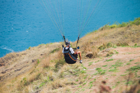 PHUKET, THAILAND -April 12 2014: An unidentified Paramania Paramotor show in Children day. Photo at Phuket, Thailandのeditorial素材