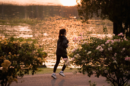 woman jogging at the garden in the eveningの写真素材