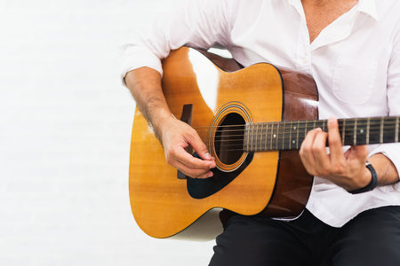 man playing guitar on white background