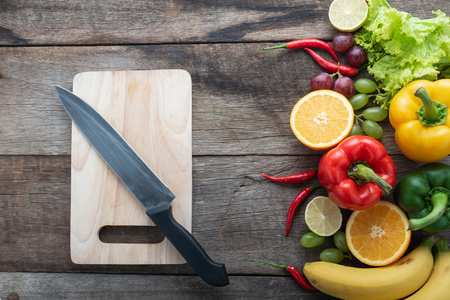fresh vegetables and fruits for fitness dinner on wooden background top view, food conceptの写真素材
