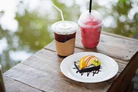brownie cake with fruits and cup of coffeeの写真素材