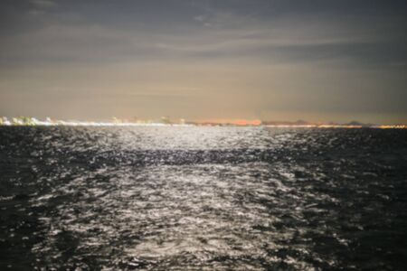 blur picture view of sea at night lightの写真素材