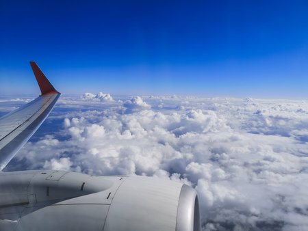 airplane flying over the clouds blue sky