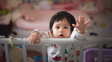 portrait of cute baby in child barrier