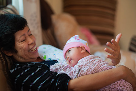 grandmother huging her granddaughter and smile, love conceptの写真素材