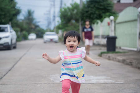 portrait of cute baby running on the roadの写真素材