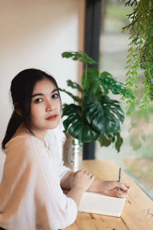 portrait cute girl playing guitar in the gardenの写真素材