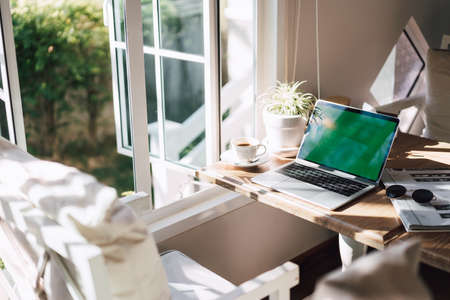 laptop and coffee on the table in the cafe, working placeの写真素材