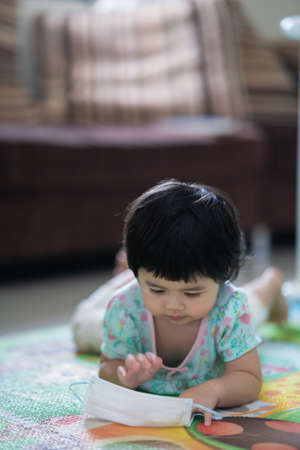 asian baby wearing surgical mask, covid coronavirus conceptの写真素材