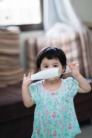 asian baby wearing surgical mask, covid coronavirus conceptの写真素材