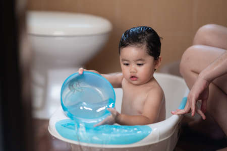 cute asian baby take a shower with her motherの写真素材