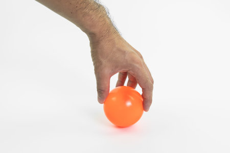 hand man holding color ball isolated on white backgroundの写真素材