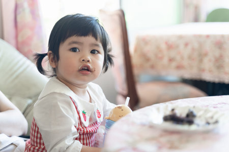 cute asian baby eating ice cream in the restaurant