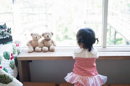 cute asian baby eating ice cream in the restaurantの写真素材