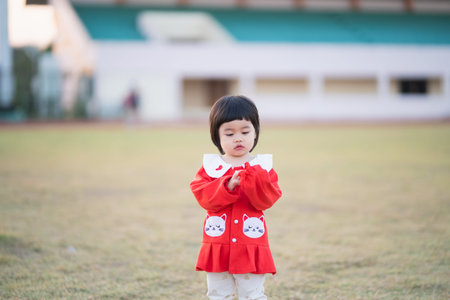 cute baby running at the stadium