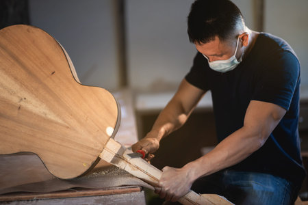 craft man making guitar on wood table, capenter working conceptの写真素材