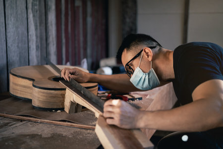 craft man making guitar on wood table, capenter working conceptの写真素材