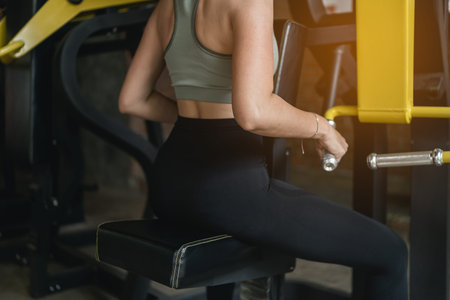 beautiful women exercise training with dumbbell in the gym, sport fitness concept