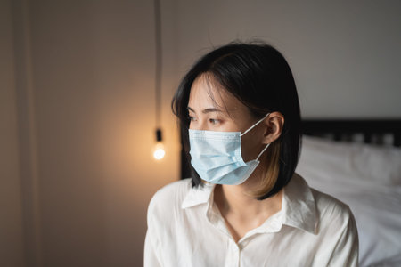 close up women wearing surgical mask in the bedroom