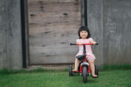 cute baby girl eating cookies in the houseの写真素材
