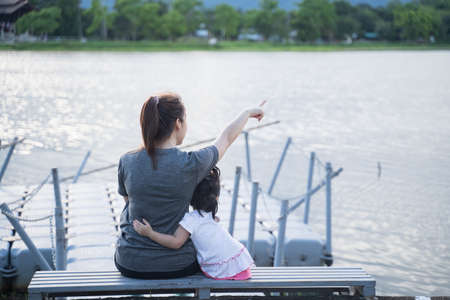 cute baby running with her mother in the garden, family happy conceptの写真素材
