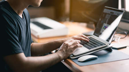 sound engineer working with laptop on the table at the home officeの写真素材