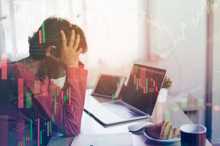 Senior woman depression and serious about checking Bitcoin price chart on digital exchange on laptopの写真素材