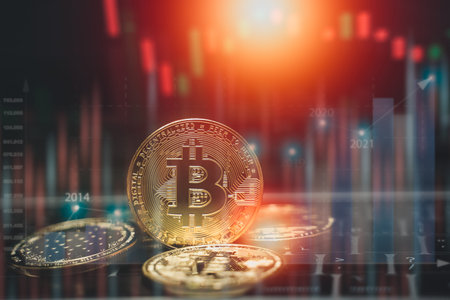 Bitcoin currency with blockchain concept on laptop keyboard with coins and charts and graphs. Crypto...