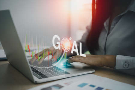 Business finance technology and investment goal concept. Businesswoman analysing forex and crypto currency trading graph. Stock market investments funds and digital assets.の写真素材
