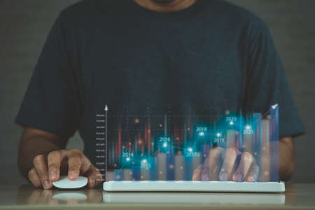 Business finance technology and investment concept. Businessman analysing forex and crypto currency trading graph. Stock market investments funds and digital assets.の写真素材