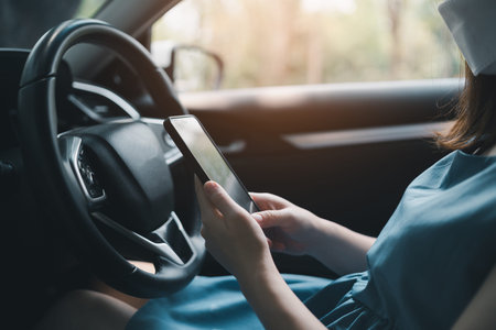 Asia woman using mobile phone while driving woman is calling insurance or someone to help when the...