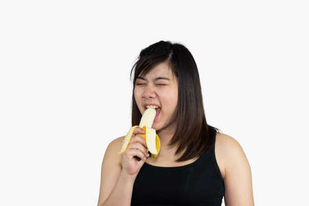 Pregnant woman holding on her belly and eat banana for health isolated on white background. Family mother mom pregnant concept.の写真素材