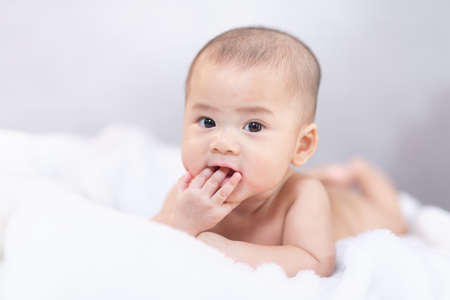 Asian baby infant sleeping on bed. Portrait baby girl studio lighting on fur bed. Baby family conceptの写真素材