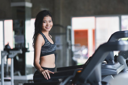 sport asian woman practicing yoga lesson, breathing, meditating, doing Ardha Padmasana exercise,...