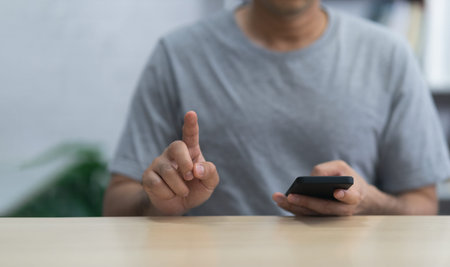 Man using smartphone and point finger touch screen sitting on table, Business metaverse technology...