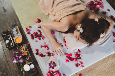 Massage and spa relaxing treatment of office syndrome traditional thai massage style. Asain female masseuse doing massage treat back pain, arm pain and stress for office woman tired from work.の写真素材