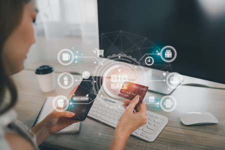 Woman holding credit card and using mobile to shopping online. asian woman working at home. Online shopping, e-commerce, internet banking, spending money, working from home concept.の写真素材