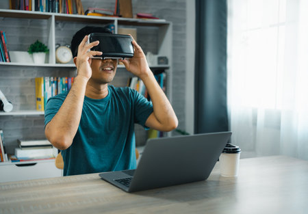 Asian man wearing VR glasses virtual global Internet connection metaverse, point finger use finger touch digital unlock, Metaverse technology management, online access to database, future technology.の写真素材