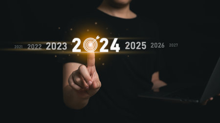 Trends 2024 year concept. Woman hold laptop and point finger touching virtual sequence count down years 2024 wording for marketing monitor business planning in new year. Technology new year concept.の写真素材