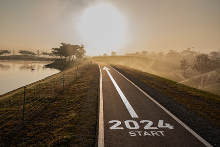 Happy new year 2024,2024 symbolizes the start of the new year. The letter start new year 2024 on the road in the nature route roadway have tree environment ecology or greenery wallpaper concept.の写真素材