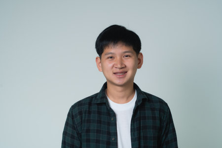 Asian man braces. Teeth braces on the white teeth of man to equalize the teeth. Bracket system in smiling mouth, close up photo teeth, macro shot, dentist health concept.の写真素材