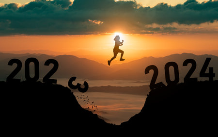 Silhouette woman jump happy new year 2024 concept, womenjumping over barrier cliff and success from 2023 cliff to 2024 cliff with sunset background. Happy New Year for web banner and advertisement.の写真素材