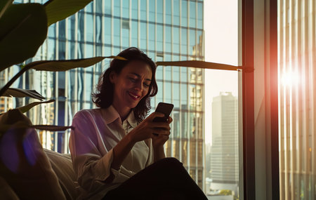 Successful young Caucasian businesswoman leader CEO standing in conferential room and using on phone with business partner while walking along the street company building. urban lifestyle concept.の素材