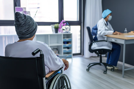 Back side view. Elderly woman consult with doctor about treatment and giving hope. Woman caretaker in white coat supporting encouraging old person. World Cancer Day Concept.の素材