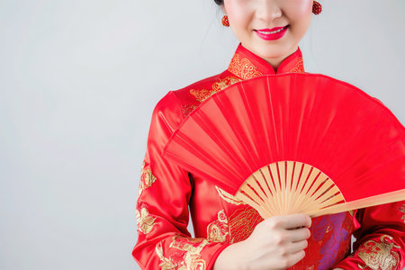 Portrait photography. Asian Chinese woman smiling in traditional cheongsam qipao dress on White or grey background. Chinese new year festival concept.の素材