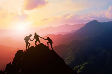 Silhouette three people helping each other hike up a mountain at sunrise or sunset. Giving a helping hand. Travel hiking journey concept.の素材