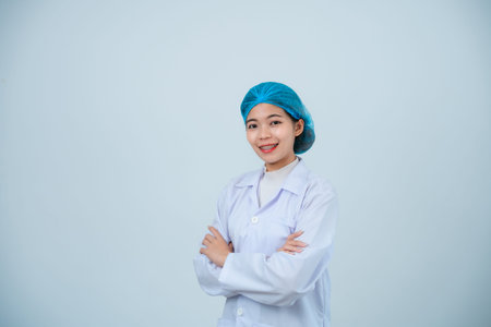 Portrait asian doctor woman, intern with stethoscope and medical robe, professional, cross arms, looking confident at camera, grey or white background.の写真素材