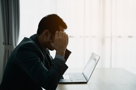 Silhouette depressed sadly serious Asian businessman having stressful depression sad time working on...